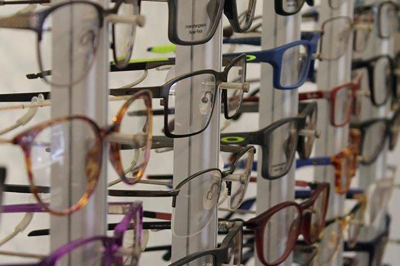 A wall of frames, tried on at your own pace, not pulled from a chain catalogue.