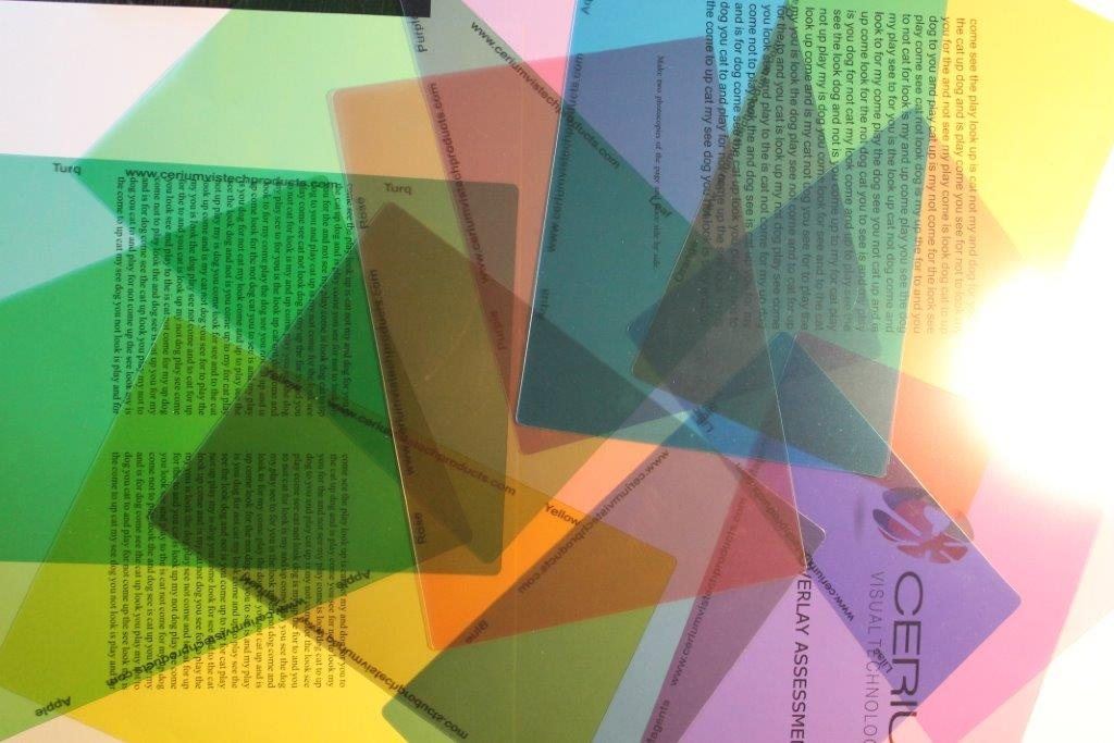 A fan of coloured Cerium overlays laid over printed text, used to assess visual stress at eyepractice